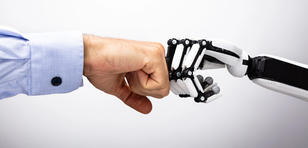 AI robot hand fistbumping a human hand