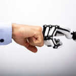 AI robot hand fistbumping a human hand